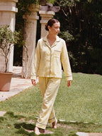 Woman wearing the Butter Yellow Piped Linen Pajama Set by Morning Lace