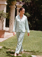 Woman wearing the Sage Green Piped Silky Pajama Set by Morning Lace